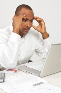 Man with a Laptop Figuring out Bills