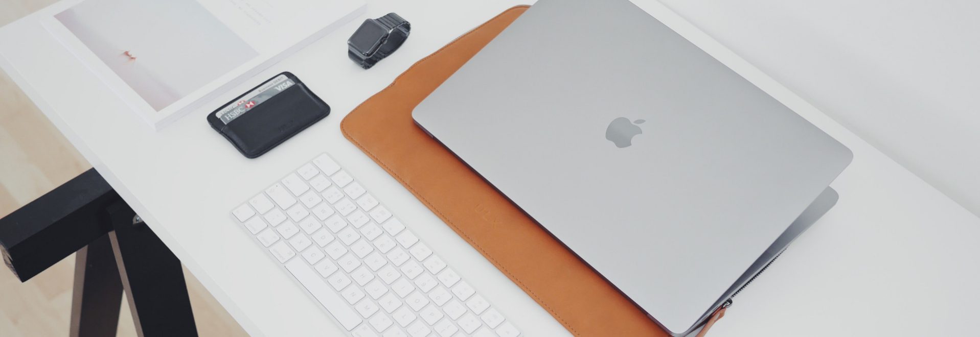 laptop and wallet on a desk