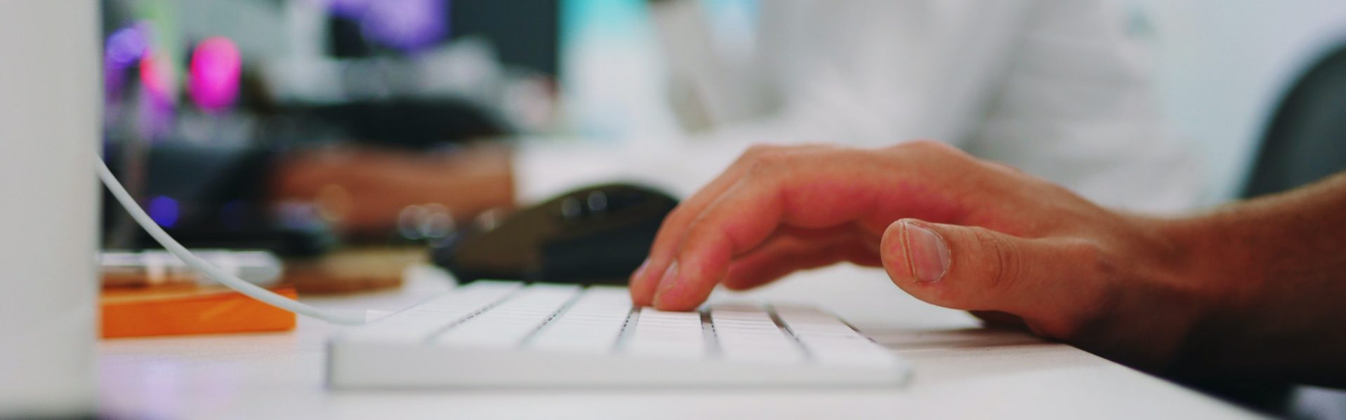 Hands typing on a keyboard